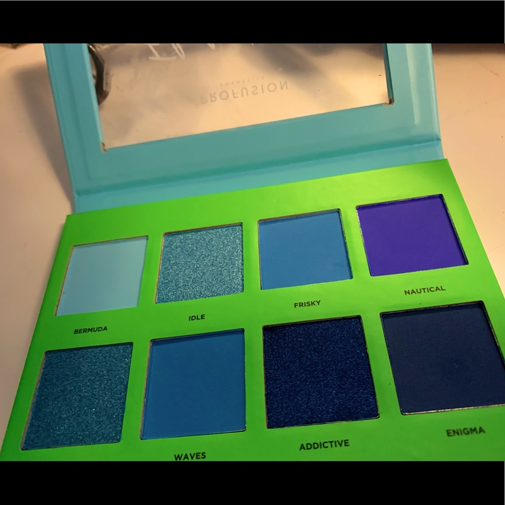blue eyeshadow palette with orange bold eyeliner (never used)